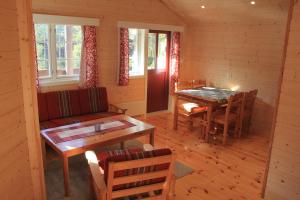 a living room with a couch and a table at Hov Hyttegrend in Viksdalen