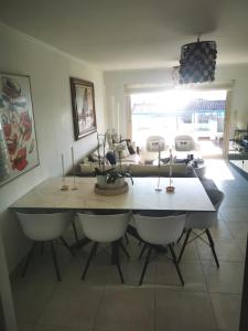 a dining room table and chairs in a living room at Residence Paradis Bleu in Cannes