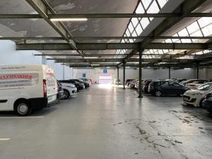 a large parking garage with cars parked in it at L'Aparté in Nancy