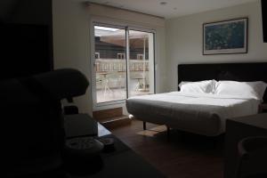 A bed or beds in a room at Apartamentos Centro Jardines