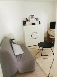 a living room with a couch and a table at Residence Paradis Bleu in Cannes