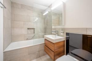 a bathroom with a sink and a shower and a toilet at LAAX Homes - Sisum La Spunda in Falera