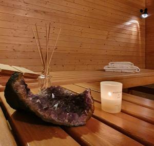 a piece of meat sitting on a table with a candle at LAAX Homes - Sisum La Spunda in Falera