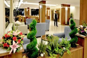 a man in a suit is standing in a lobby at تمايا الخبر Tamaya Alkhobar in Al Khobar