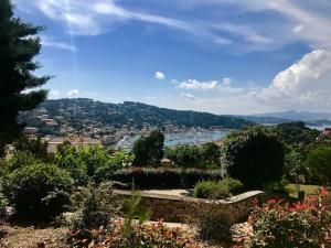 a view of a city from a garden at Les Hibiscus in Saint-Mandrier-sur-Mer