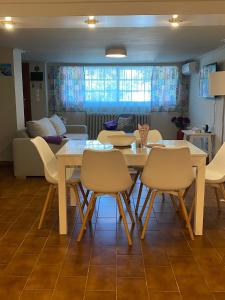 a dining room with a table and chairs and a couch at Agapis Residence in Kalívia Thorikoú