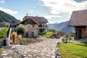 a stone path in front of a house at Spornberg Mountain Living Nordberg in Soprabolzano
