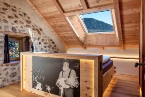 a room with a picture of a man on a wall at Spornberg Mountain Living Nordberg in Soprabolzano