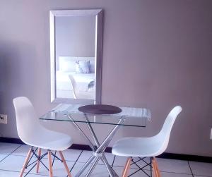 a table and chairs in a room with a mirror at Samtip Sunset in Johannesburg