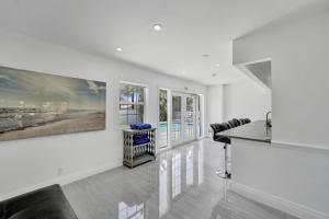 a kitchen with white walls and windows and a counter at Luxurious Villa with Pool in Hollywood