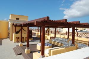 a pergola on the roof of a building at El Mosaico Del Sol in Lampedusa