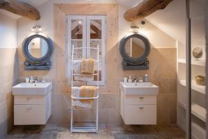 a bathroom with two sinks and two mirrors at Clos Saint Jacques - Maison d'Hôtes in Meursault