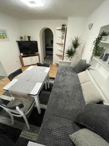 a living room with a table and a couch at Dambach Appartement in Rossleithen