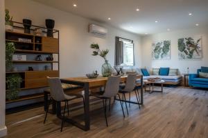 a living room with a dining room table and chairs at Katergo Luxury Villas in Stoupa