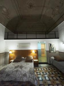 a bedroom with a large bed and a ceiling at Resort CostantiNapoli 27 in Naples