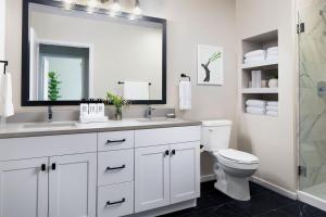 a bathroom with a sink and a toilet and a mirror at Sentral Old Town in Scottsdale