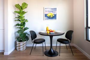 a table and chairs in a room with a plant at Sentral Old Town in Scottsdale
