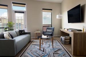 a living room with a couch and a table at Sentral Old Town in Scottsdale