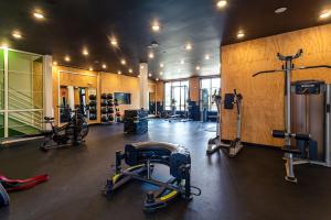 a gym with several treadmills and machines in a room at Kasa FreeMoreWest Charlotte in Charlotte