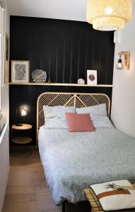a bedroom with a bed and a black wall at GITES des FLANDAINES in Saint-Jean-en-Royans