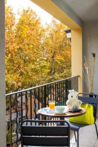 a teddy bear sitting on a table on a balcony at Hôtel Escaletto in Aix-en-Provence