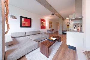 a living room with a couch and a table at trendy STUDIO ROTTERDAM CENTER in Rotterdam