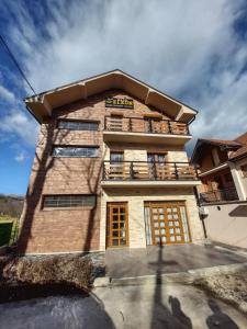 a tall building with a balcony on top of it at Eleon Motel in Brezovica