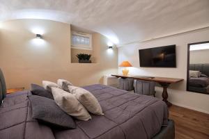 a bedroom with a bed with pillows and a desk at PALAZZO TESTA - LOCAZIONE TURISTICA in Florence