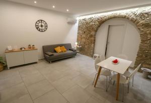 a living room with a couch and a table at Casanica-Taormina in Taormina