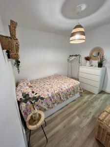 a bedroom with a bed and a table and a dresser at Anne´s Corner in Cala del Moral