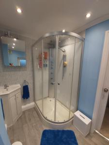 a bathroom with a shower and a sink at White House in Chapeltown