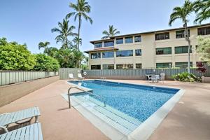 a swimming pool in front of a building at Modern and Cozy Condo Near Beaches with Coastal Views in Kahana