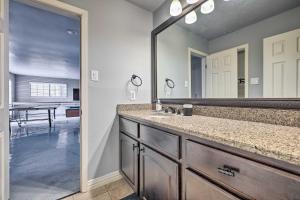 a bathroom with a sink and a large mirror at Canyon Lake Home Hill Country and Water Views! in Canyon Lake +35 photos