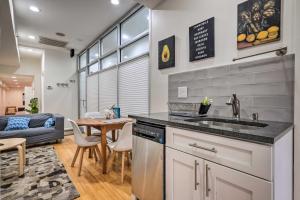a kitchen with a sink and a living room at Modern Townhome in Historic Dtwn Alexandria! in Alexandria