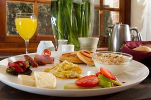 a plate of food on a table with a glass of orange juice at Hotel Boutique El Consulado in La Paz