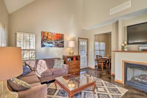 a living room with a couch and a fireplace at Heber Springs Cabin about 1 Mi to Sugarloaf Mtn! in Heber Springs