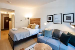 a hotel room with a bed and a couch at Impeccable Glacier Lodge Hotel Room w Pool+Hot Tub in Whistler