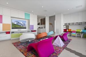a living room with colorful chairs and a flat screen tv at Ski Palace in Park City