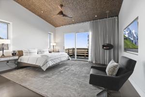 a bedroom with a bed and a chair at Ski Palace in Park City