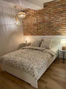 Posteľ alebo postele v izbe v ubytovaní APARTAMENTY GUZIK