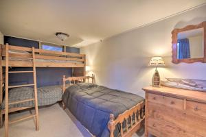 a bedroom with two bunk beds and a desk at Beautiful Chetek Home with Prairie Lake Access! in Chetek