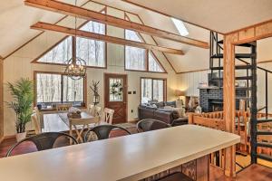 a living room with a table and chairs at Fire Pit and Grill Woodside Nest in Pocono Lake! in Pocono Lake