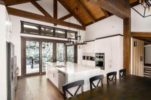 a kitchen with a white counter and a table and chairs at 360 Chalet in Big Sky