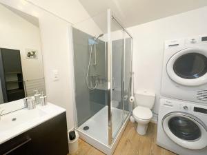 a bathroom with a shower and a washing machine at Maison centre Les Pieux*Wifi*OXO in Les Pieux