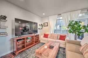 a living room with a couch and a tv at Sleek Seattle Home with Rooftop Patio and Views! in Seattle