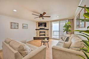 a living room with a couch and a fireplace at Beachfront Oceanside Condo with Amenity Access! in Oceanside