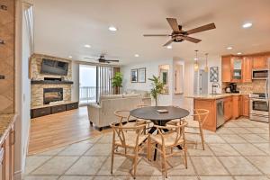 a kitchen and living room with a table and chairs at Beachfront Oceanside Condo with Amenity Access! in Oceanside