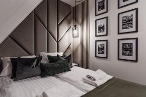 a bedroom with a large bed with a wooden headboard at Góralska Antresola Apartament z Widokiem na Giewont in Kościelisko