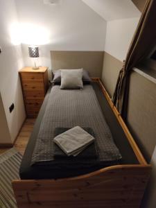 - un lit avec un cadre en bois dans une chambre dans l'établissement Apartments Battistutti Zagreb, à Zagreb