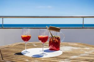 two glasses of wine on a table on a boat at Praia Mar by OCvillas in Albufeira